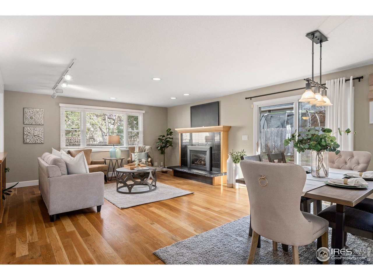 1490 Periwinkle Drive Boulder, CO 80304 - Photo 3 of 25 a living room with furniture a flat screen tv and a large window