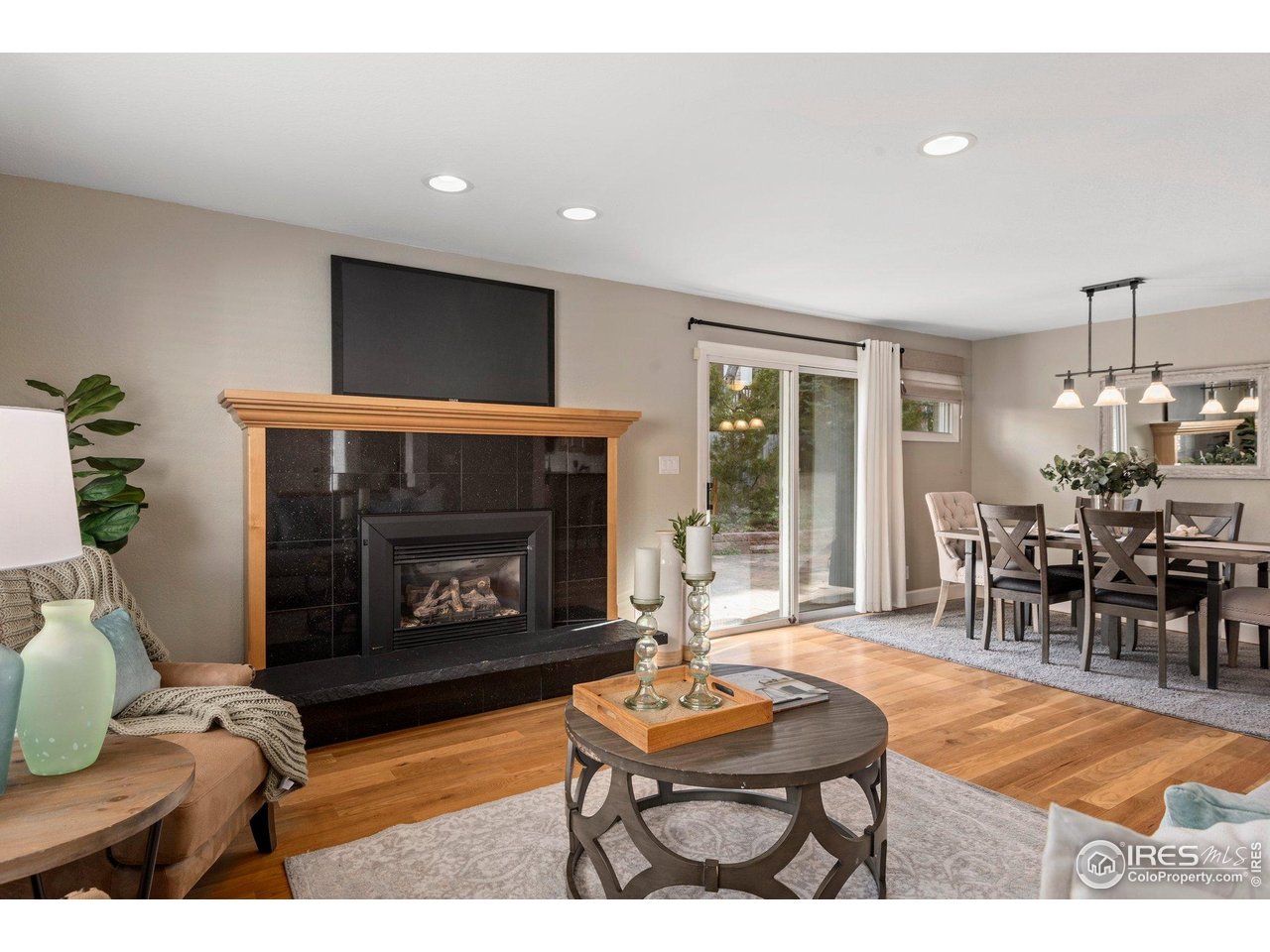 1490 Periwinkle Drive Boulder, CO 80304 - Photo 5 of 25 a living room with furniture a flat screen tv and a fireplace