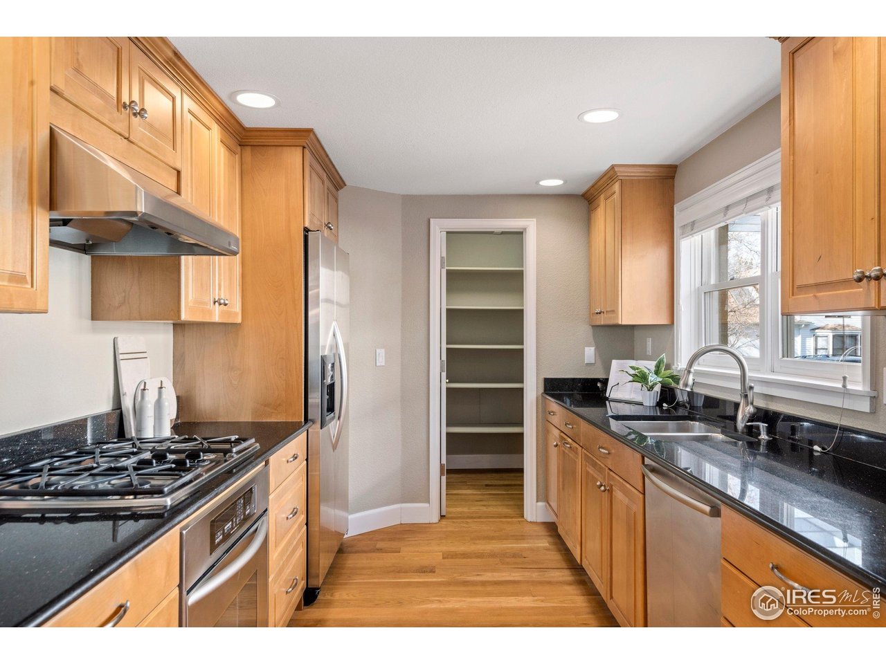1490 Periwinkle Drive Boulder, CO 80304 - Photo 9 of 25 a kitchen with stainless steel appliances granite countertop a stove a sink and a refrigerator