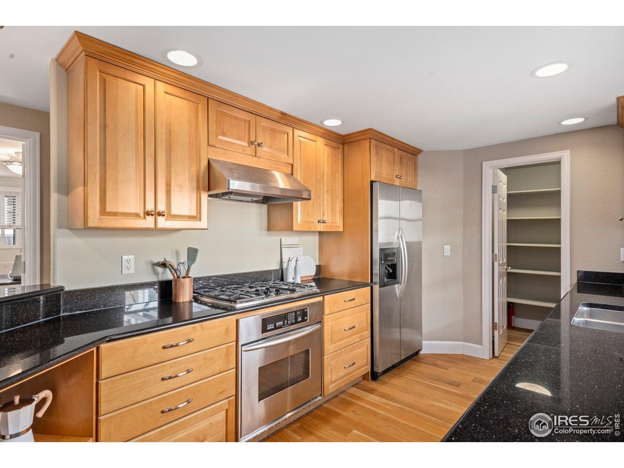 1490 Periwinkle Drive Boulder, CO 80304 - Photo 10 of 25 a kitchen with stainless steel appliances granite countertop a refrigerator and a stove top oven