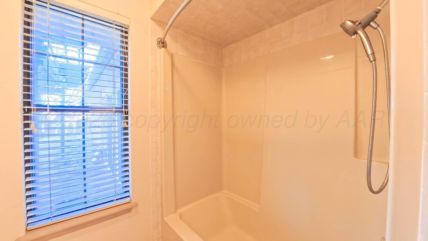 4311 Arp Place Amarillo, TX 79109 - Photo 14 of 36 a bathroom with a shower