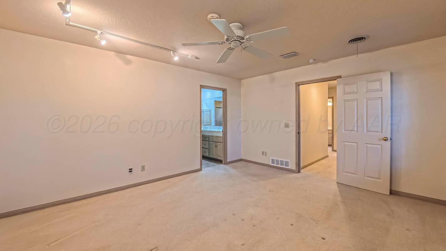 4311 Arp Place Amarillo, TX 79109 - Photo 18 of 36 an empty room with ceiling fan and windows