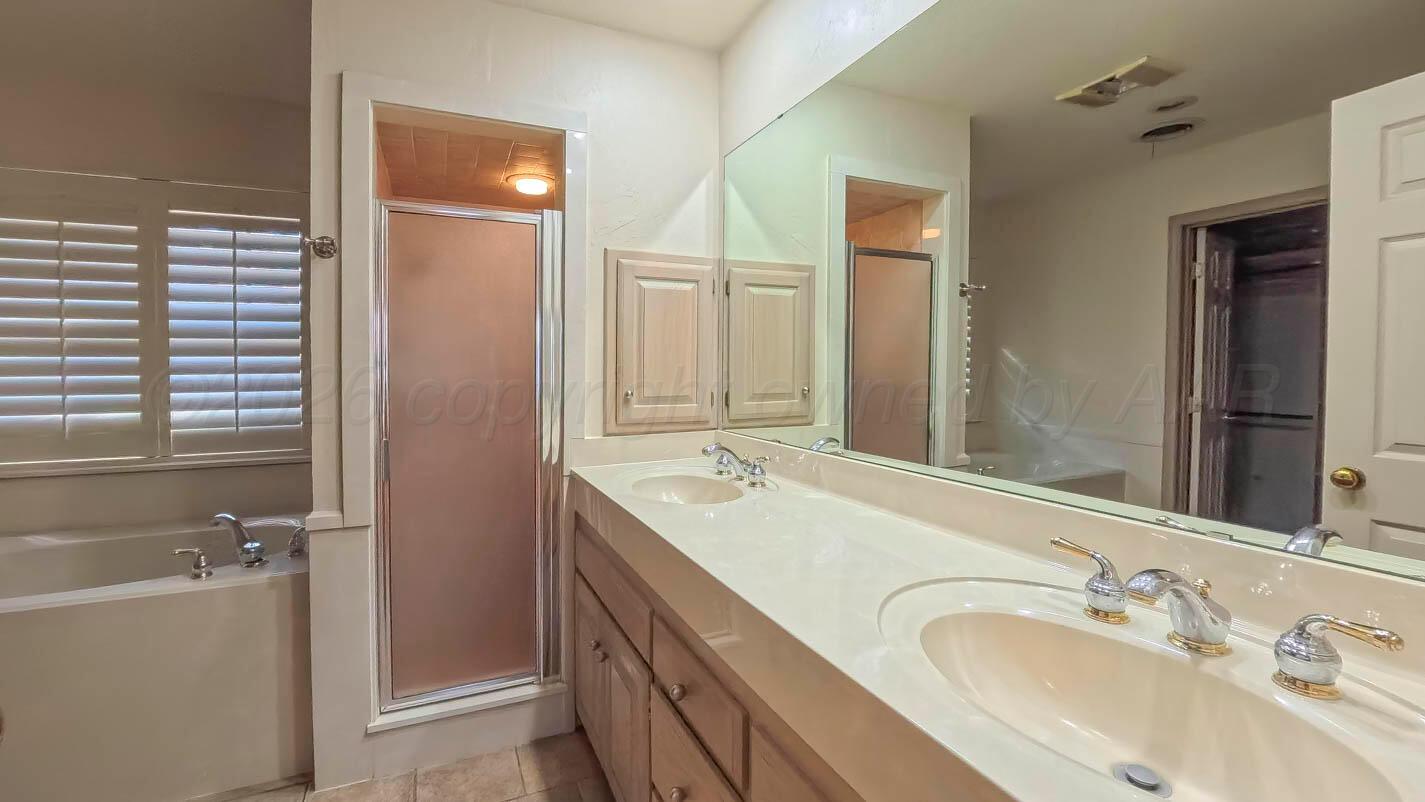 4311 Arp Place Amarillo, TX 79109 - Photo 19 of 36 a bathroom with a granite countertop sink mirror and double
