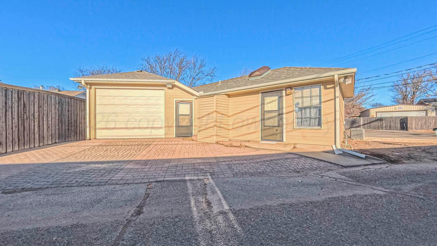4311 Arp Place Amarillo, TX 79109 - Photo 30 of 36 a front view of a house with a garage