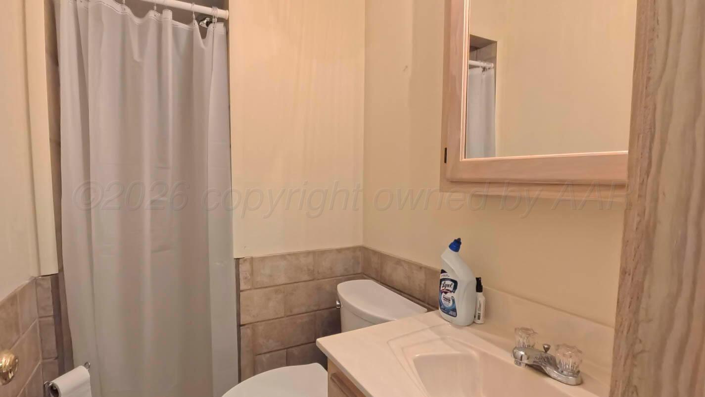 4311 Arp Place Amarillo, TX 79109 - Photo 34 of 36 a bathroom with a sink and toilet