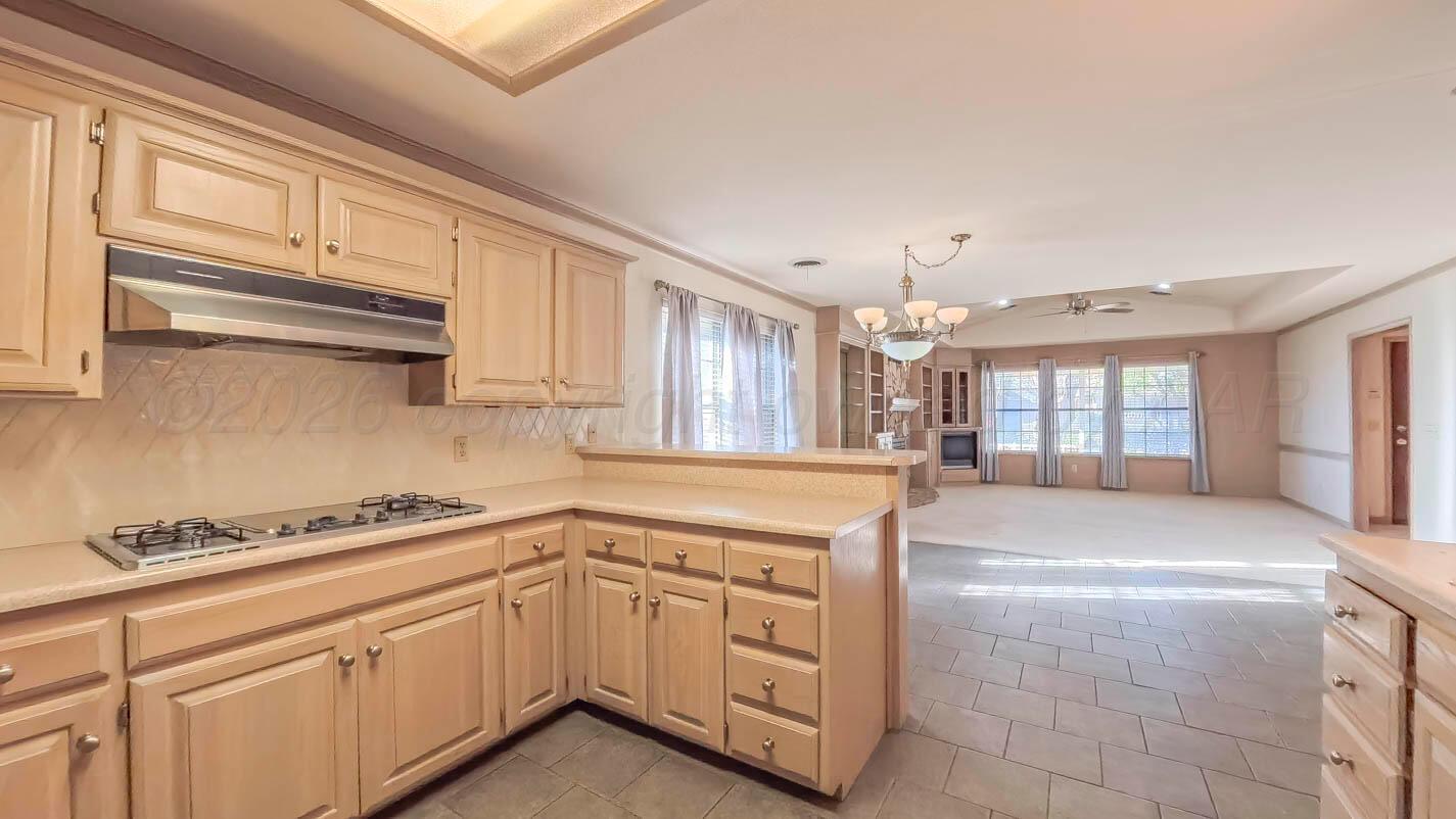 4311 Arp Place Amarillo, TX 79109 - Photo 10 of 36 a kitchen with granite countertop a sink stove and cabinets