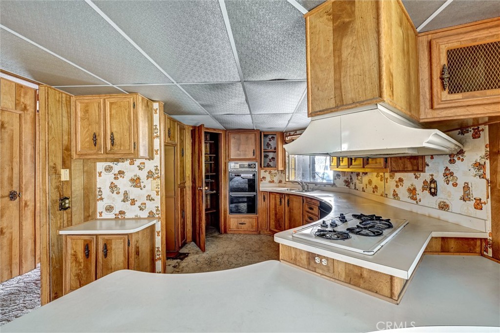 1348 Jasmine Way Hemet, CA 92545 - Photo 17 of 33 a kitchen with stainless steel appliances granite countertop a stove and a refrigerator