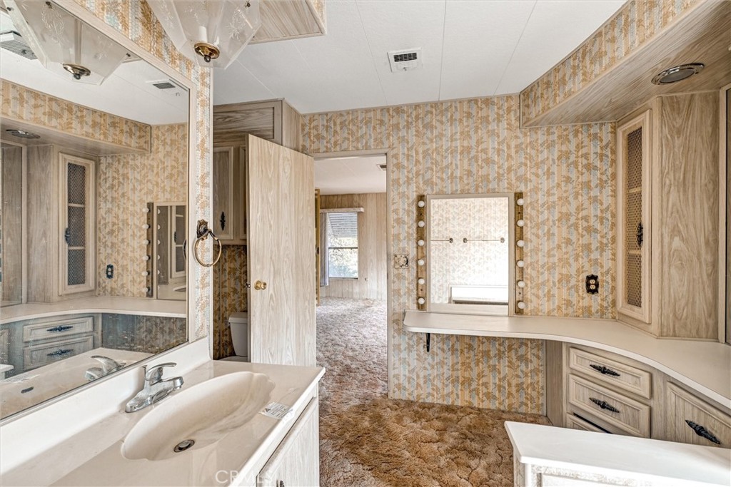 1348 Jasmine Way Hemet, CA 92545 - Photo 28 of 33 a bathroom with a double vanity sink mirror and shower
