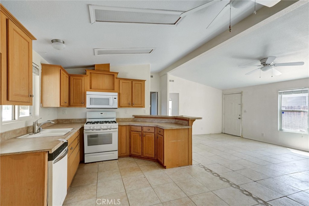 1348 Jasmine Way Hemet, CA 92545 - Photo 9 of 33 a kitchen with stainless steel appliances granite countertop a stove a sink dishwasher and a refrigerator