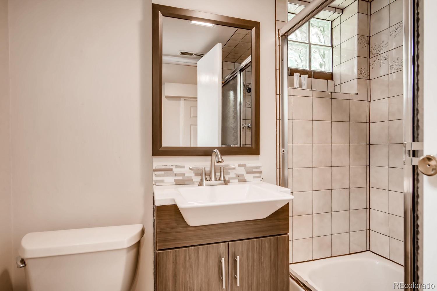 777 South Sherman Street Denver, CO 80209 - Photo 19 of 35 a bathroom with a sink a toilet and shower
