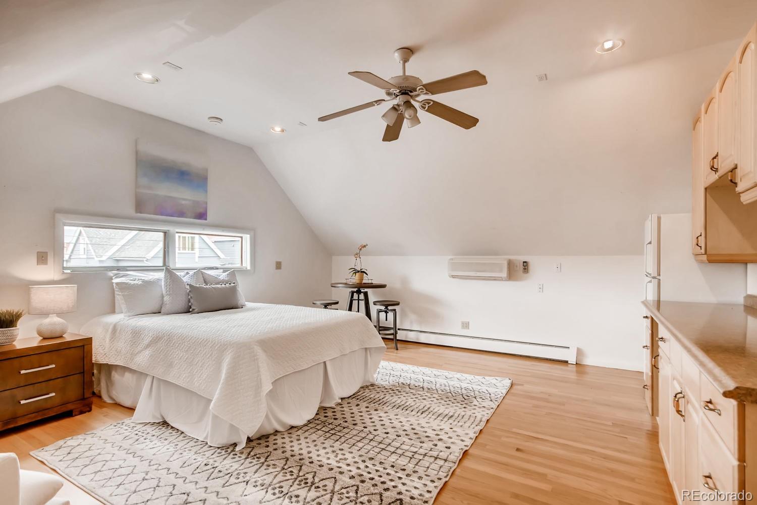 777 South Sherman Street Denver, CO 80209 - Photo 26 of 35 a bedroom with a bed and wooden floor