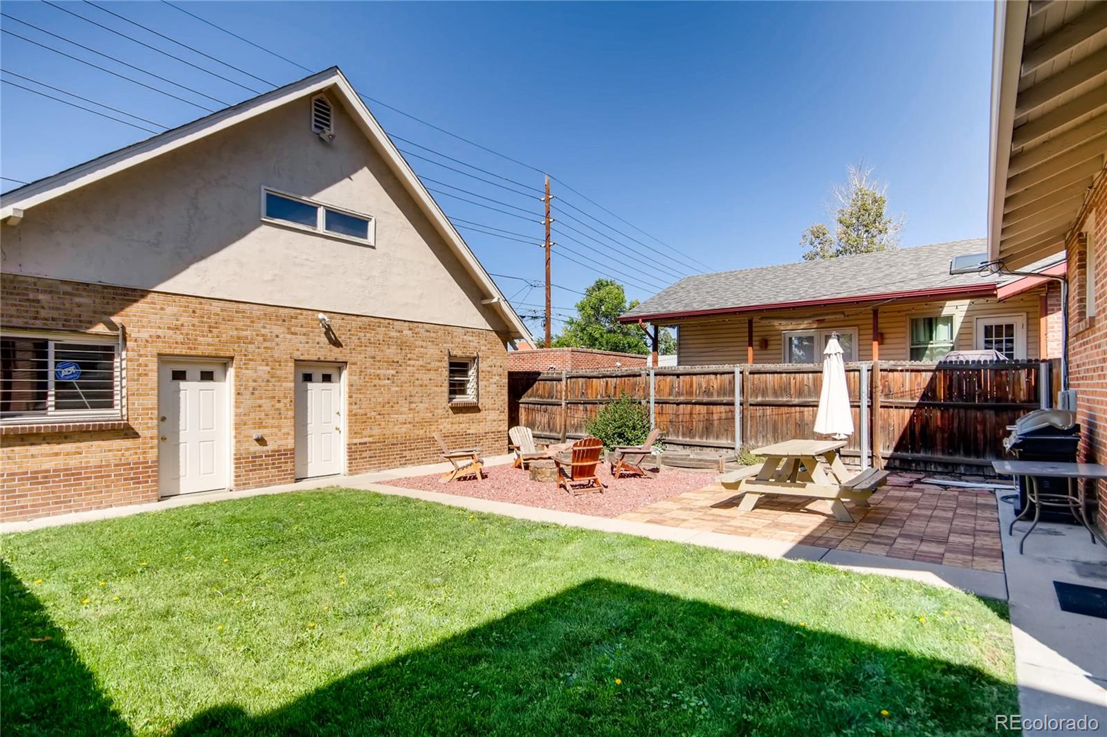 777 South Sherman Street Denver, CO 80209 - Photo 30 of 35 a front view of a house with a yard patio and fire pit