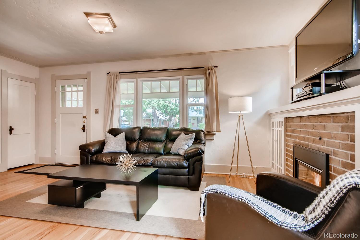 777 South Sherman Street Denver, CO 80209 - Photo 7 of 35 a living room with furniture and a flat screen tv