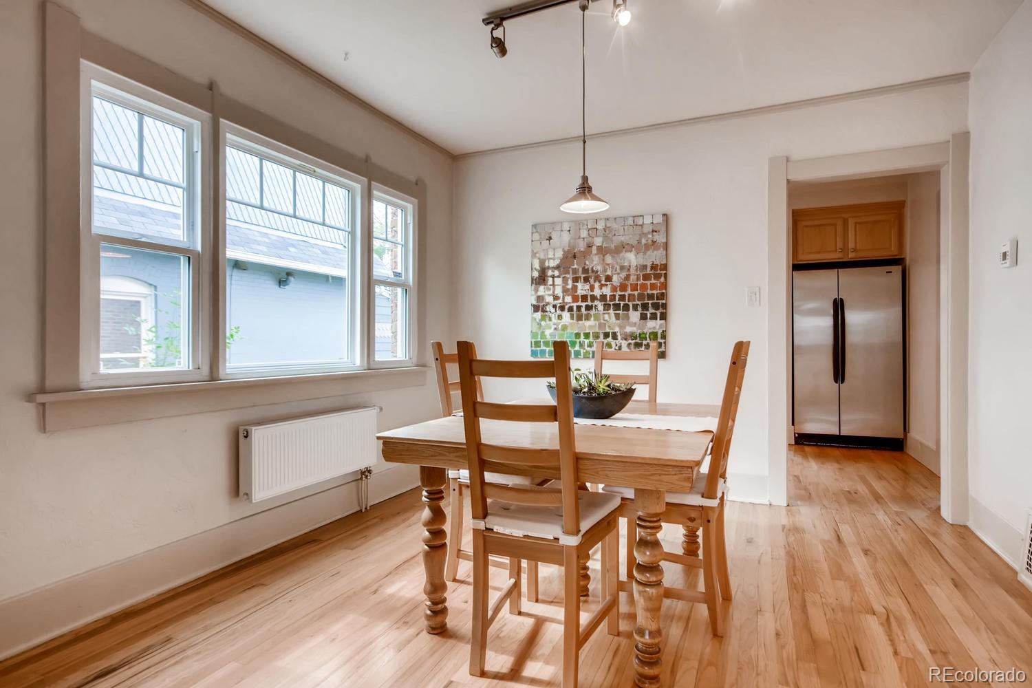 777 South Sherman Street Denver, CO 80209 - Photo 8 of 35 a view of a dining room with furniture window and wooden floor