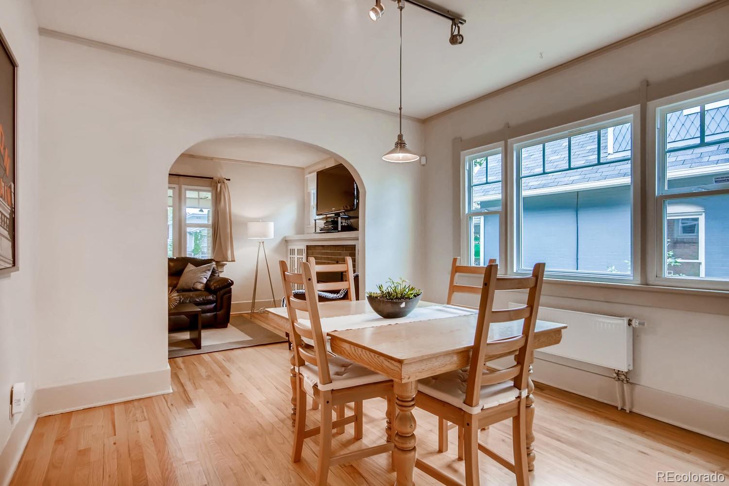 777 South Sherman Street Denver, CO 80209 - Photo 9 of 35 a view of a dining room with furniture window and wooden floor