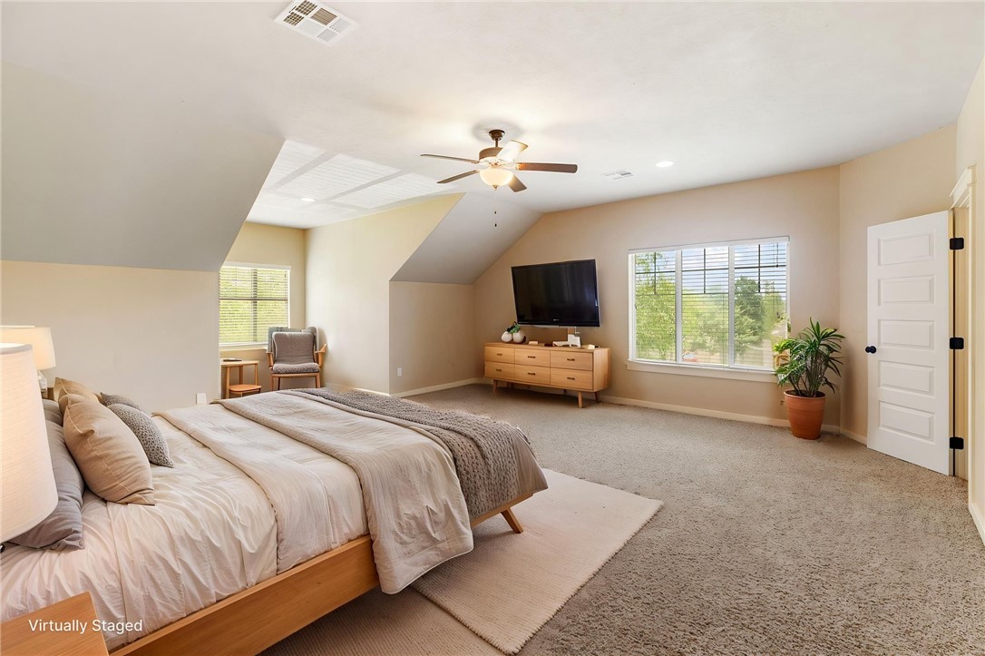 2136 Rockcliffe Loop College Station, TX 77845 - Photo 47 of 48 a spacious bedroom with a bed and a chandelier