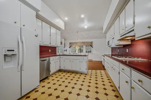 a kitchen with granite countertop a refrigerator and a stove