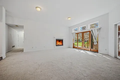 an empty room with windows and ceiling fan