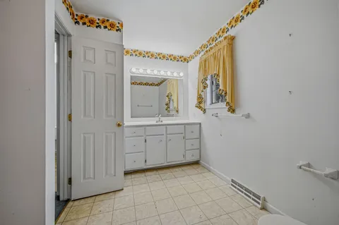 a bathroom with a sink a mirror and a vanity