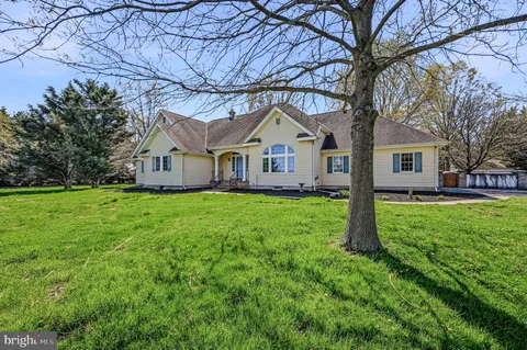 a front view of house with yard and green space