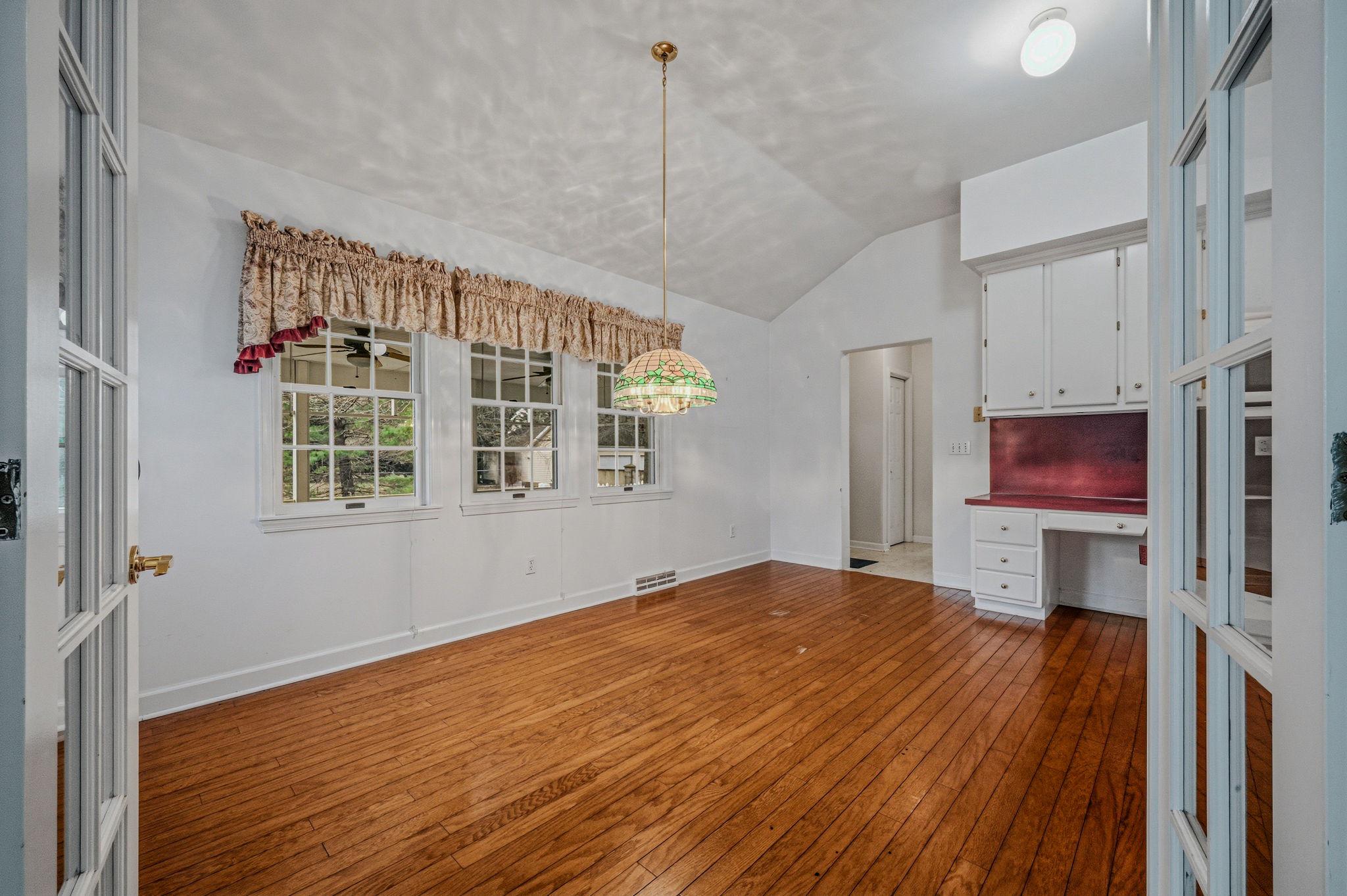 812 Taylors Bridge Road Townsend, DE 19734 - Photo 7 of 45 a view of a room with wooden floor a ceiling fan and a window