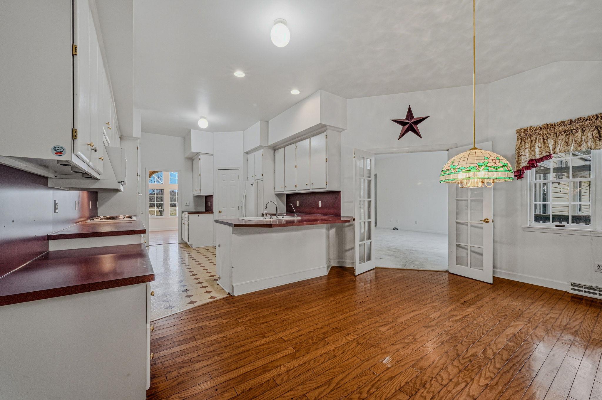812 Taylors Bridge Road Townsend, DE 19734 - Photo 8 of 45 a kitchen with stainless steel appliances granite countertop a refrigerator a stove and a wooden floors