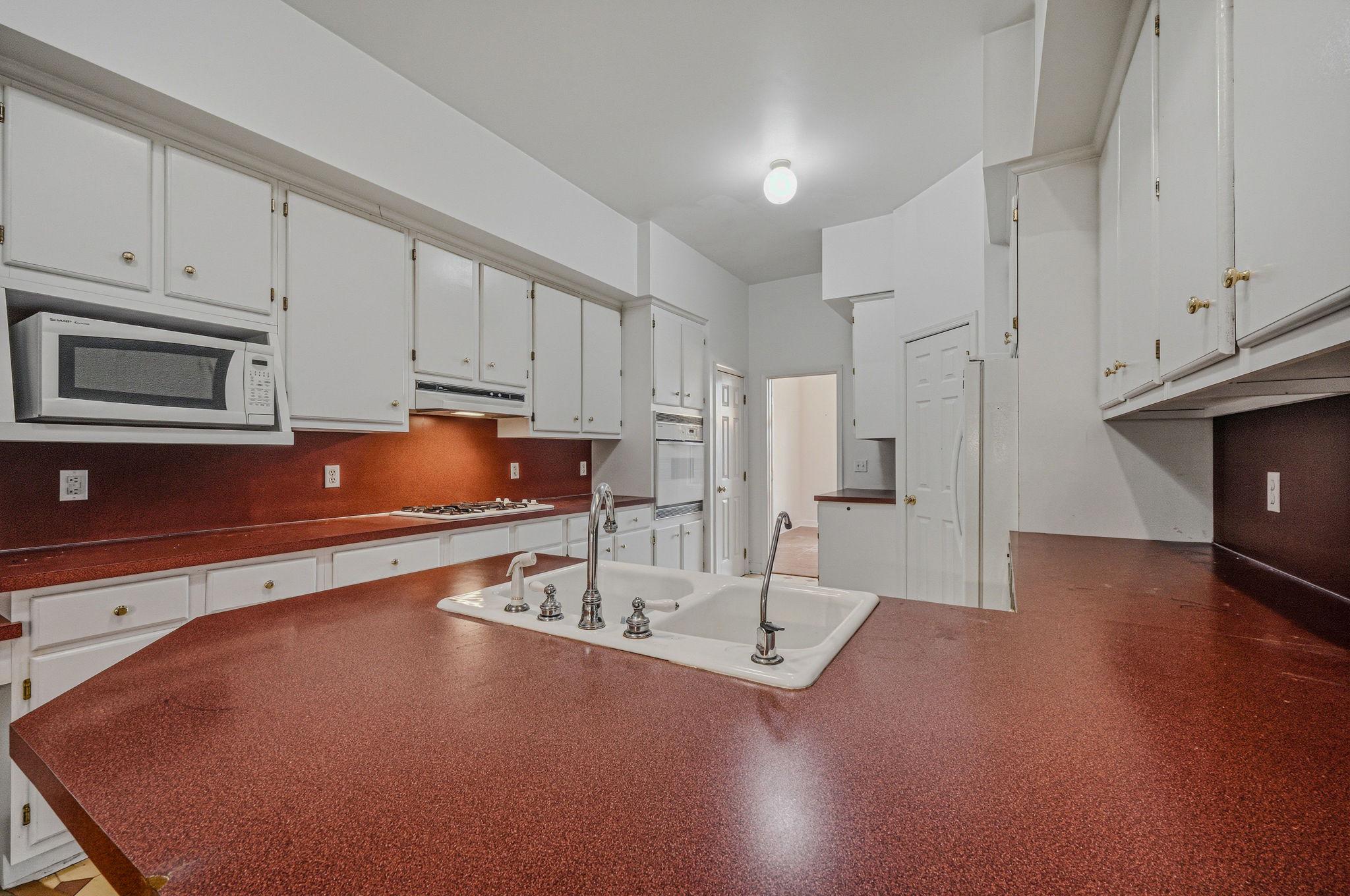 812 Taylors Bridge Road Townsend, DE 19734 - Photo 9 of 45 a kitchen with stainless steel appliances granite countertop a sink white cabinets and a stove