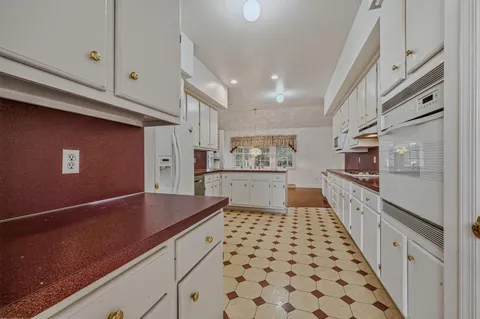 a kitchen with stainless steel appliances a refrigerator and cabinets