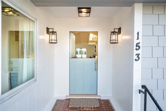 a view of a hallway with windows and a bathroom