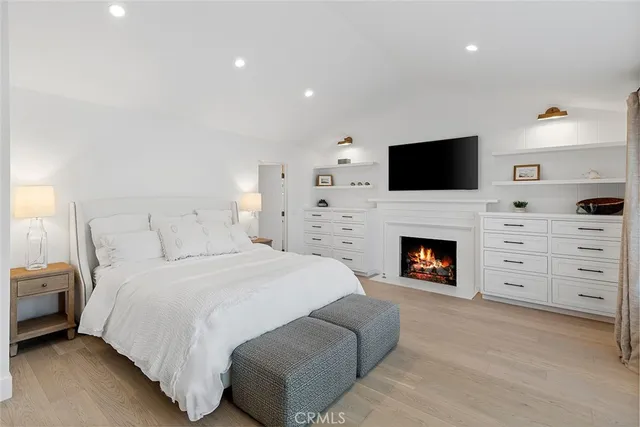a spacious bedroom with a bed and a fireplace