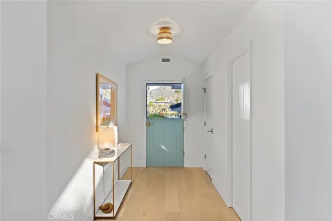a view of a bedroom with wooden floor and windows