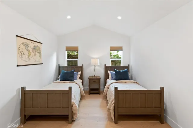 a bedroom with two beds and a couch