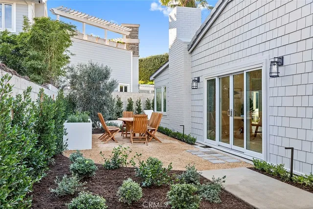 a view of a patio with table and chairs and potted plants