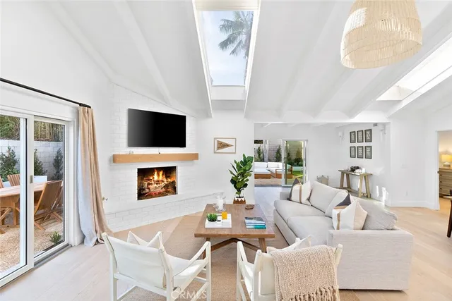 a living room with fireplace furniture and a flat screen tv