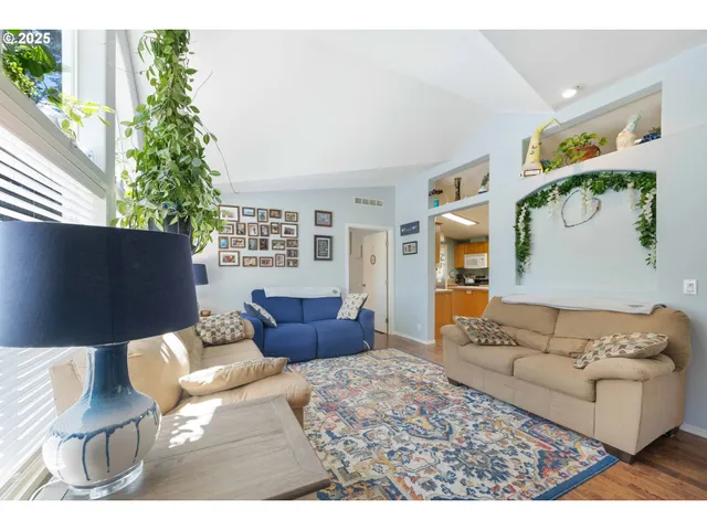 a living room with furniture and a potted plant