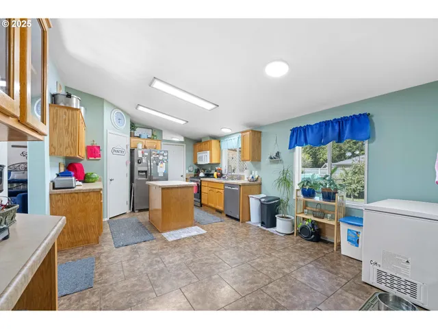 a living room with furniture and a kitchen