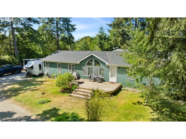 a view of a house with pool and sitting area