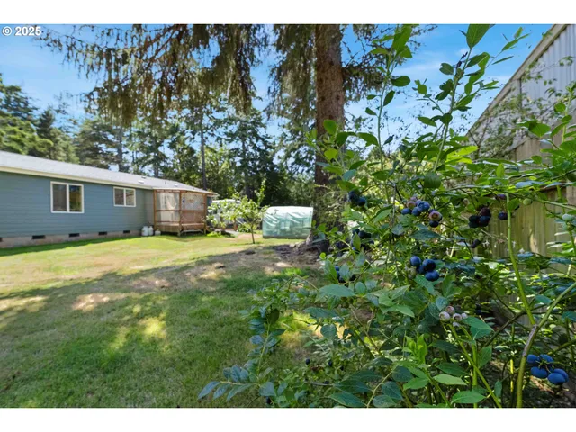 a view of a house with a yard and sitting area
