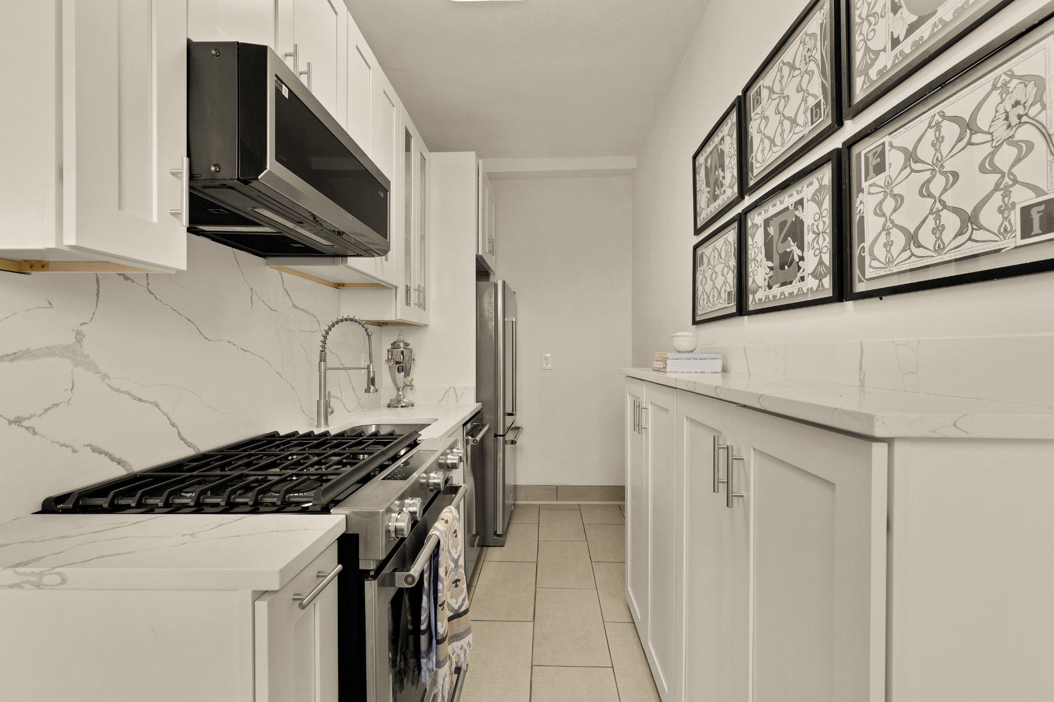 644 Massachusetts Avenue Northeast, Unit 400 Washington, DC 20002 - Photo 13 of 24 a kitchen with stainless steel appliances granite countertop a sink stove and microwave