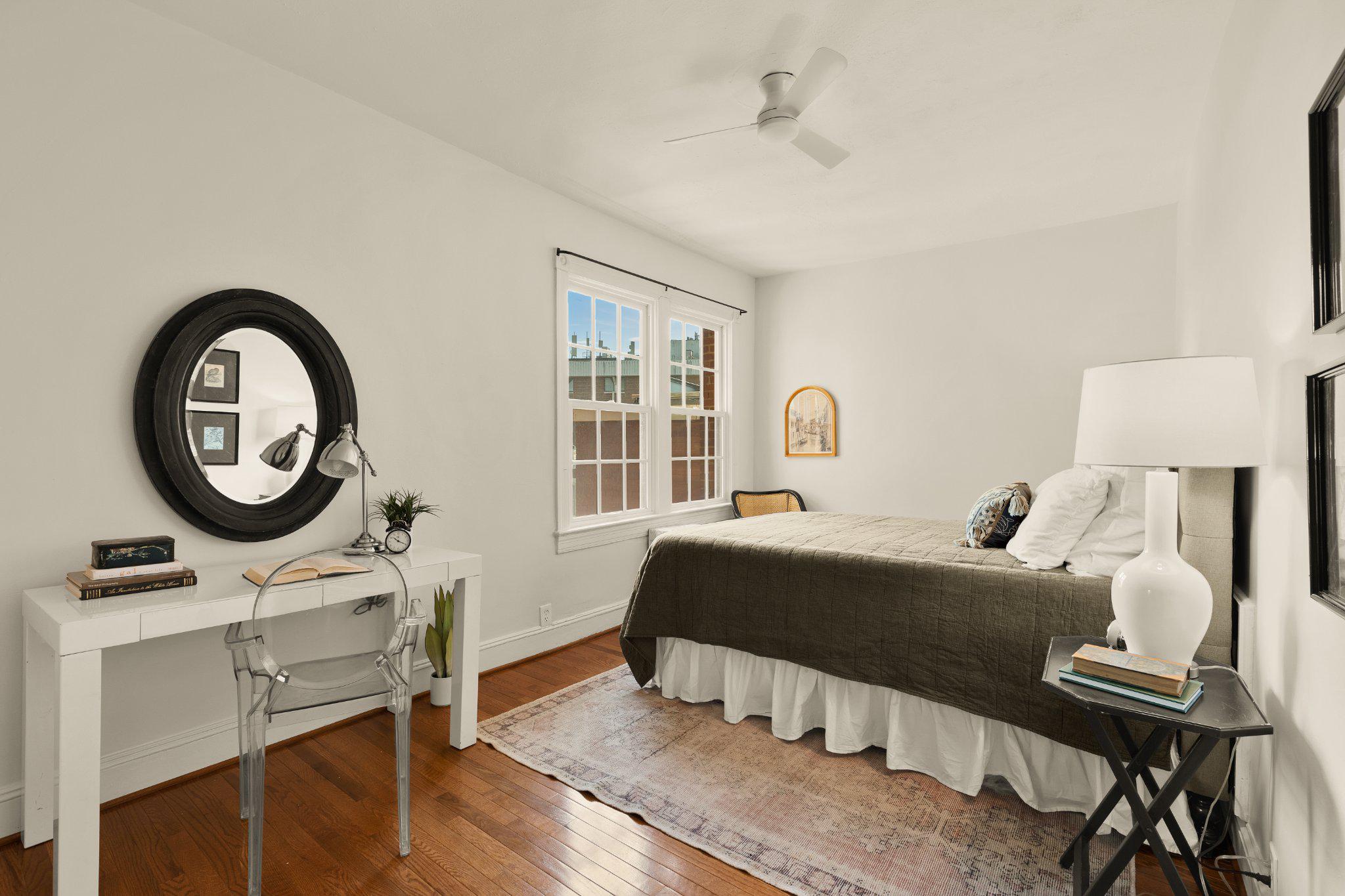 644 Massachusetts Avenue Northeast, Unit 400 Washington, DC 20002 - Photo 15 of 24 a bedroom with a bed a desk and chair