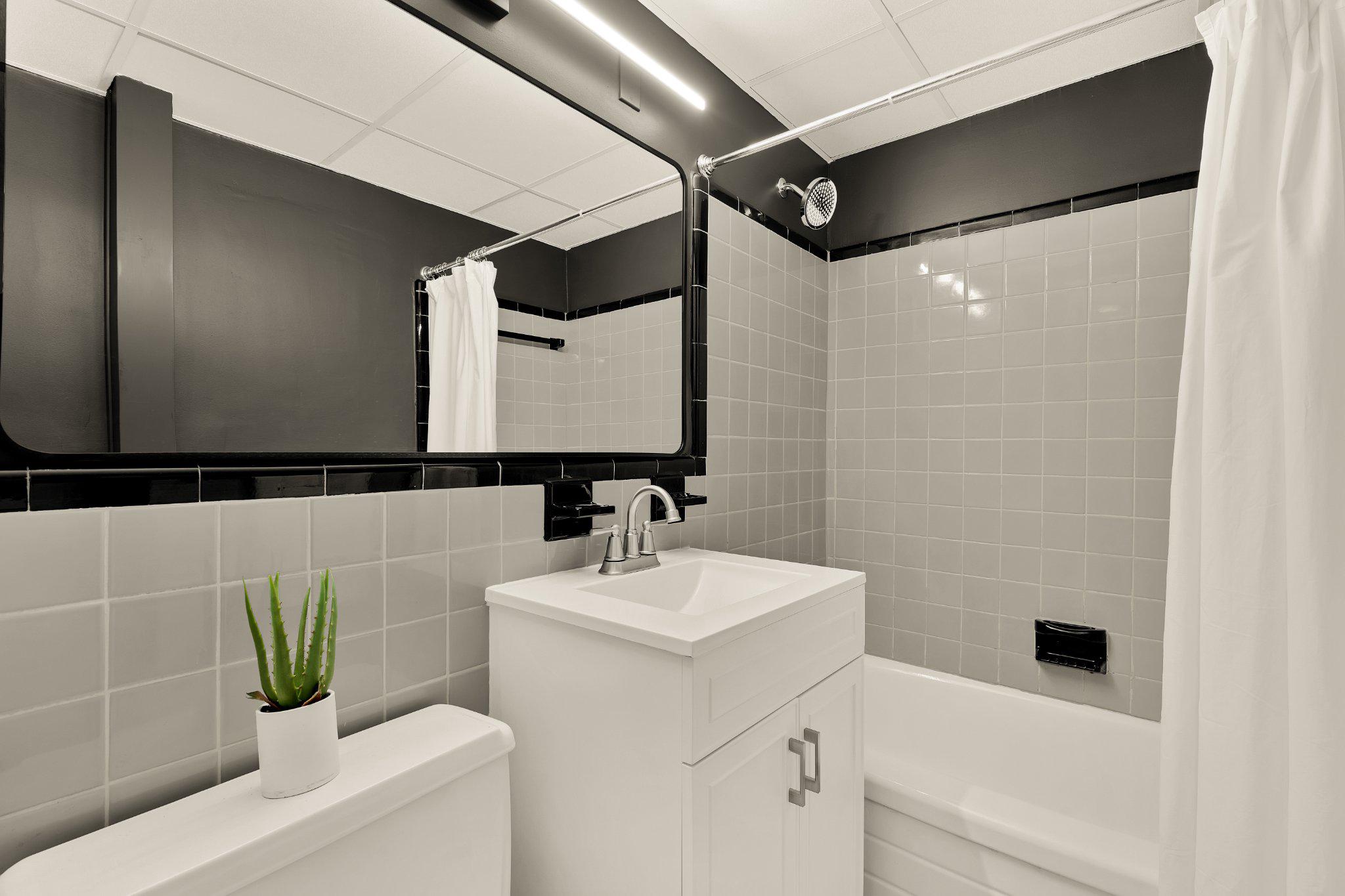 644 Massachusetts Avenue Northeast, Unit 400 Washington, DC 20002 - Photo 17 of 24 a bathroom with a sink a toilet and shower