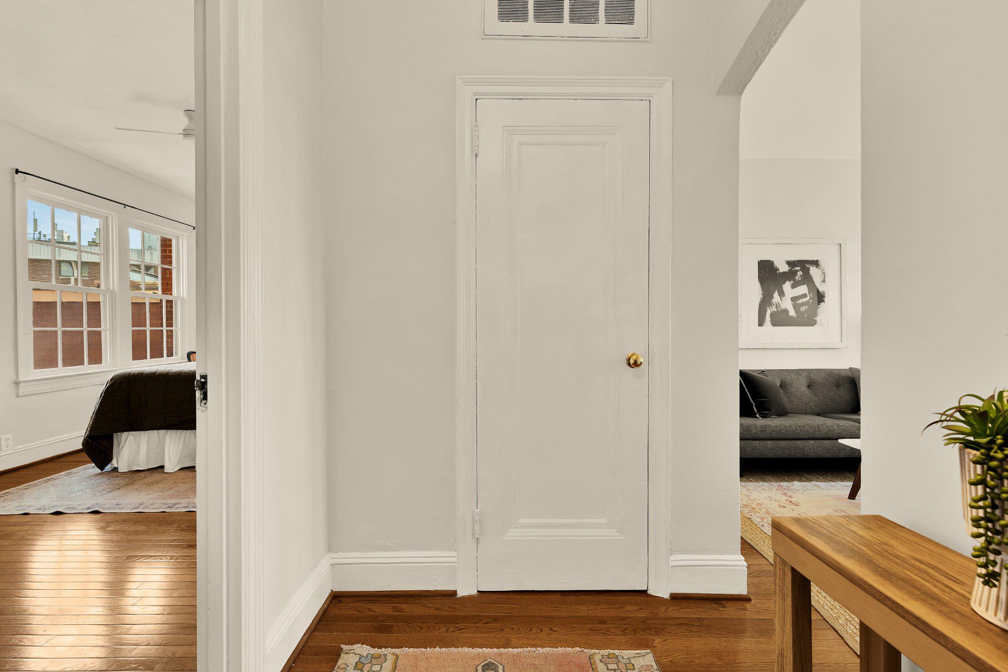 644 Massachusetts Avenue Northeast, Unit 400 Washington, DC 20002 - Photo 2 of 24 a bedroom with a bed and wooden floor