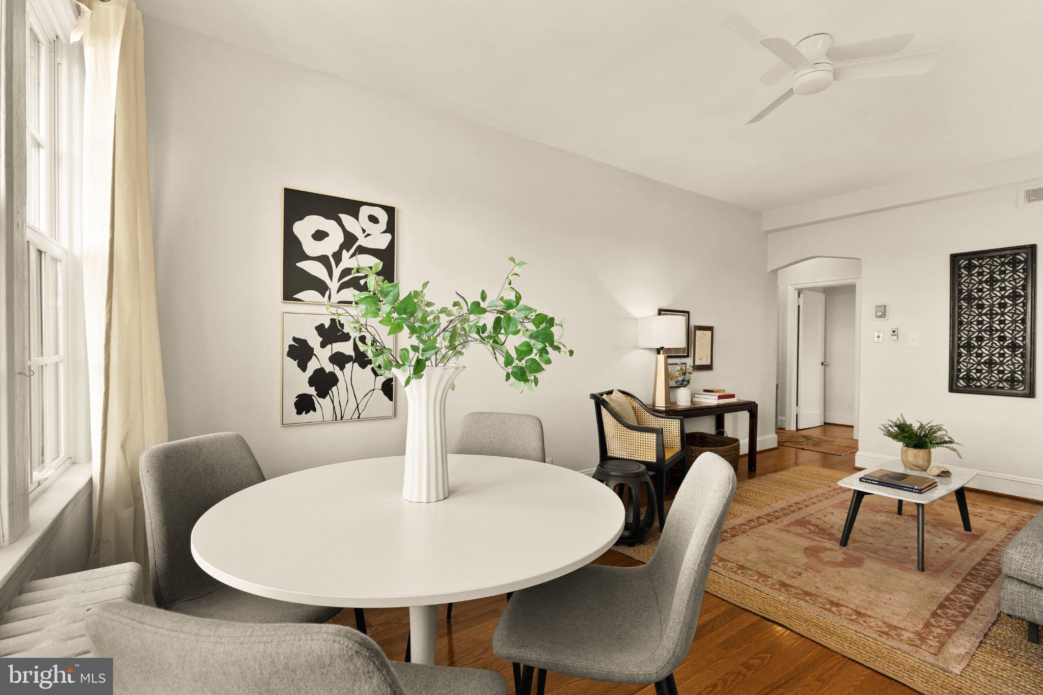 644 Massachusetts Avenue Northeast, Unit 400 Washington, DC 20002 - Photo 7 of 24 a dining room with furniture potted plants and wooden floor