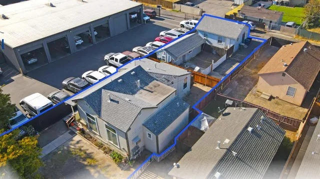 an aerial view of a house with a street