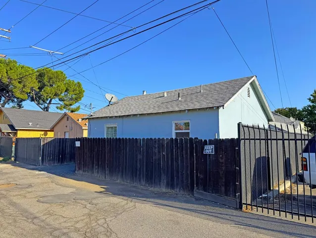 a view of a house with wooden fence