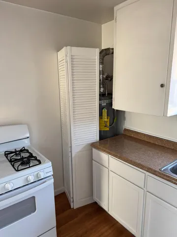 a kitchen with a cabinets and white appliances