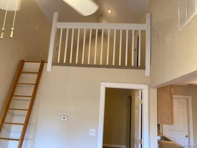 a view of staircase with railing and a window