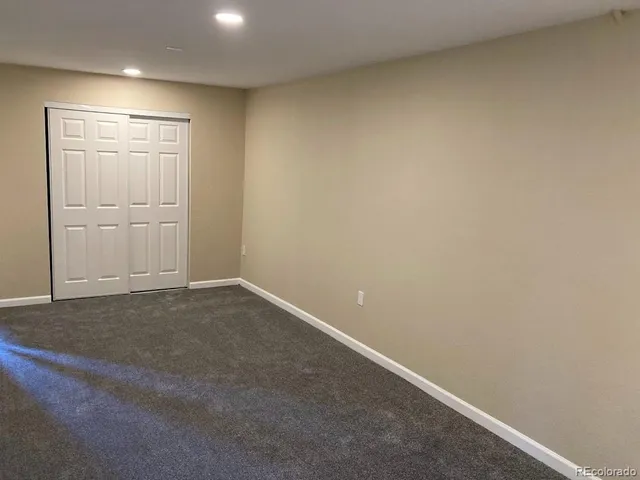 an empty room with closet area