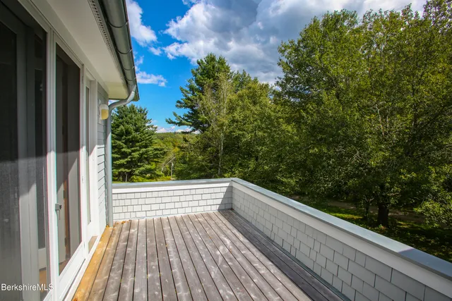 a view of balcony with wooden floor and fence