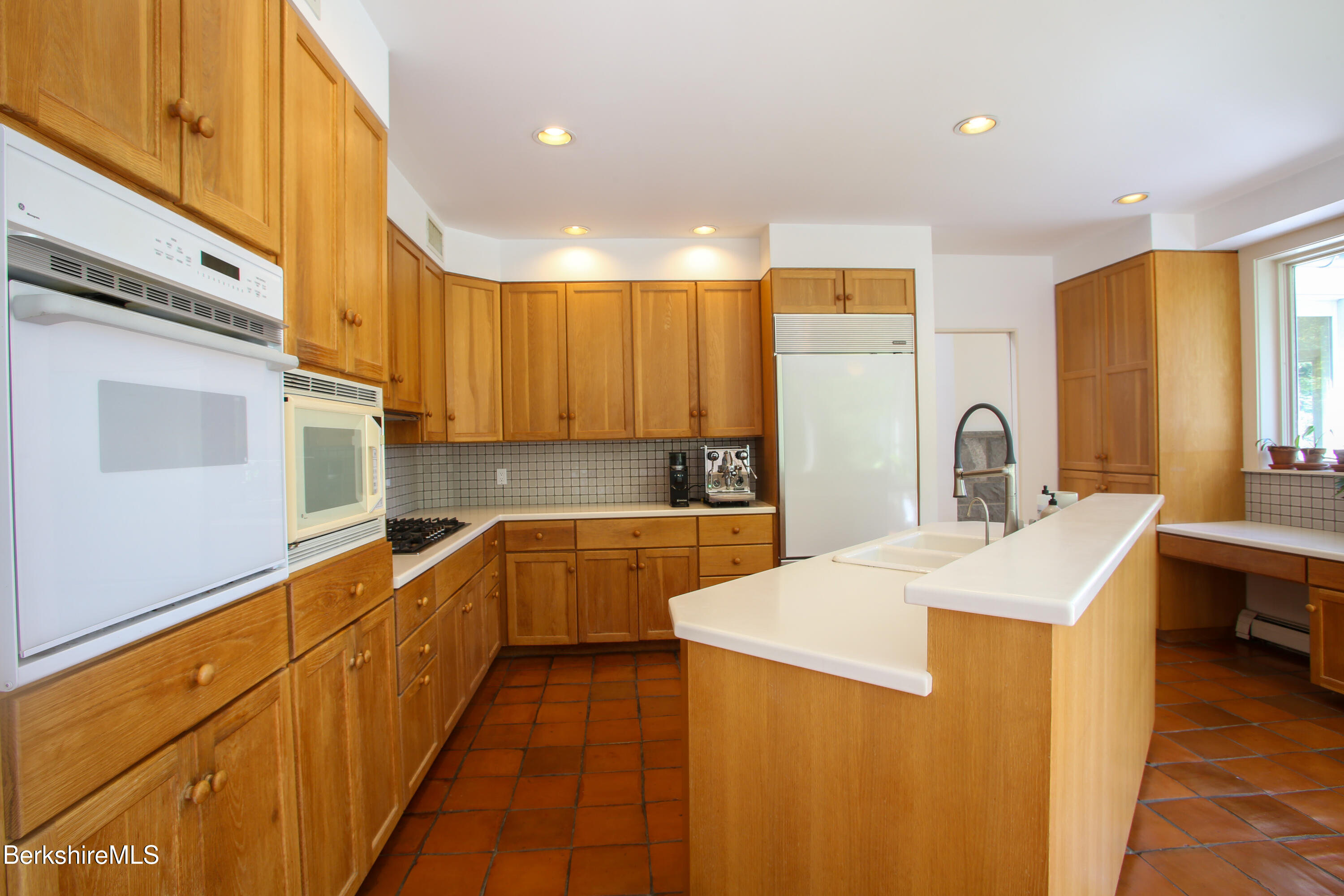 240 Beldingville Road Ashfield, MA 01330 - Photo 19 of 45 a large kitchen with stainless steel appliances a sink dishwasher a stove top oven a refrigerator with wooden cabinets and floor